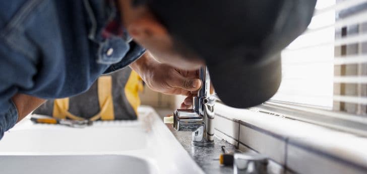 plumber fixing a sink